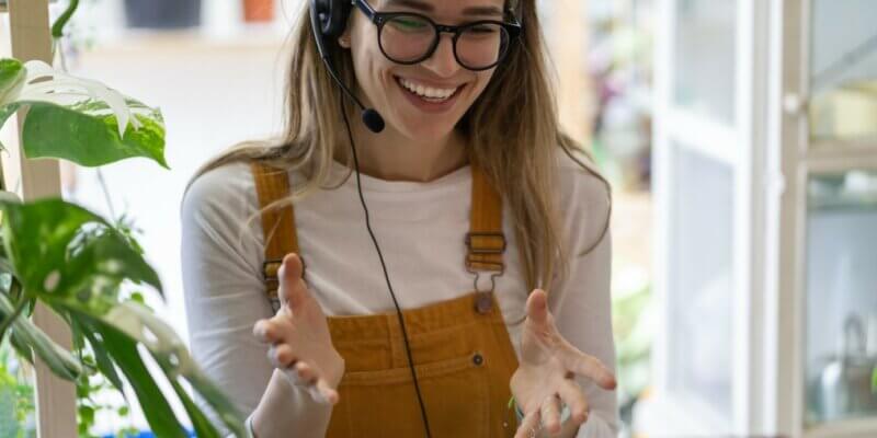 smiling employee on headset zoom call - keeping clients happy