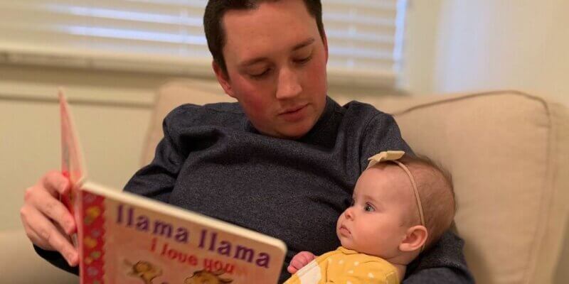 preston eyre reading book "The Grumbles" to baby daughter